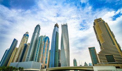 Fototapeta na wymiar Panoramic view of top of skyscrapers in Dubai Marina at cloudy day. UAE