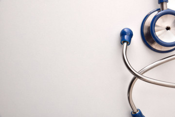 Blue stethoscope on white table close up - obrazy, fototapety, plakaty