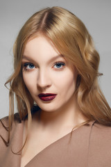 Beautiful fashion model with clean fresh face with natural makeup. Blue eyes and red lips.