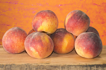 Red and ripe peaches on a rustic wood