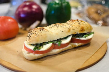 A caprese sandwich with blurred background