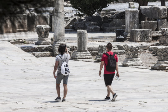 Tourists walking on a road of the antique city of Ephesus
