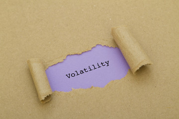 Volatility word written under torn paper.