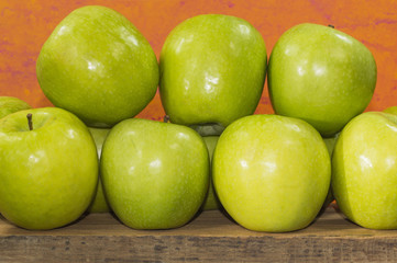 green apples of the granny smith variety on a wood
