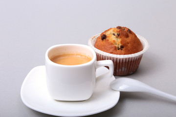 Classic espresso in white cup with homemade cake and chocolate on white background.