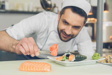  Man japanese restaurant chef cooking in the kitchen