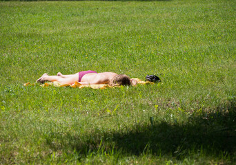 Girl sunbath on grass