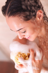 Young beautyful woman under shower in bathroom