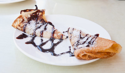 Pancakes with kiwi jam, grated coconut and chocolate