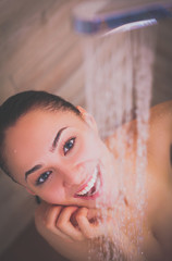 Naklejka premium Young beautyful woman under shower in bathroom