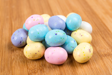 Fototapeta na wymiar Pastel chocolate malted eggs on a wood background