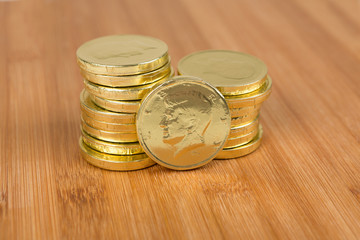 Chocolate gold coins on a wood background