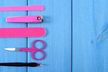 Accessories for manicure or pedicure, copy space for text on blue boards