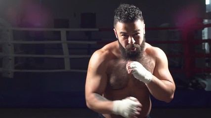Portrait of a boxer working out the bumps in the ring. A young man in training for Boxing