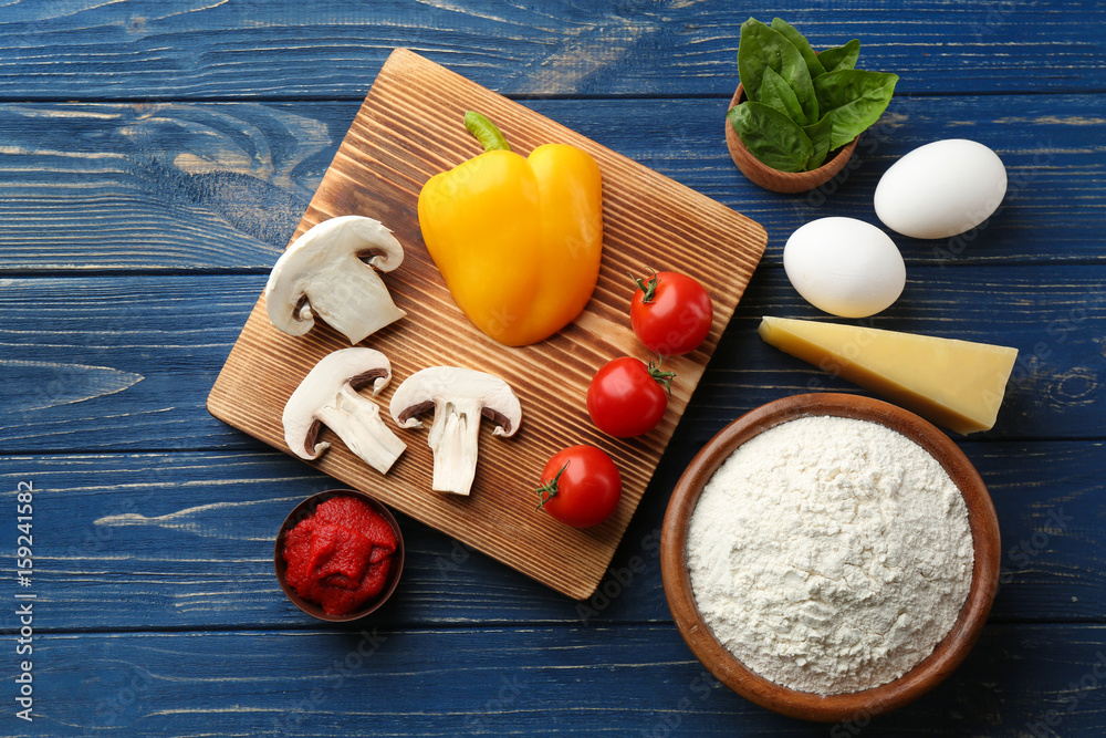 Wall mural ingredients for pizza on wooden background