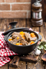 Delicious braised beef meat in broth with vegetables, goulash