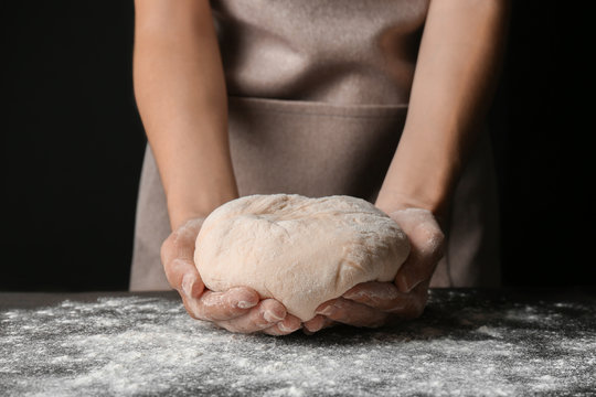 Female hands holding dough