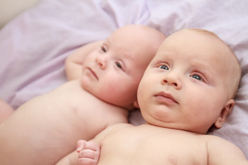 indoor portrait of two young baby twins at home