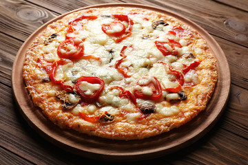 Tasty pizza on wooden table