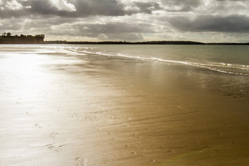 sea coast line with sand beach at stormy weather