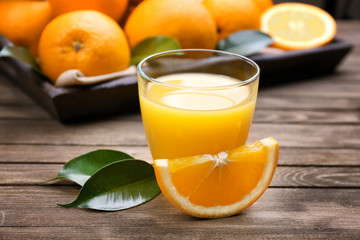 Fresh orange juice with fruits on table