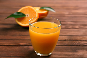 Fresh orange juice with fruits on table