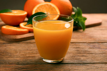 Fresh orange juice with fruits on table