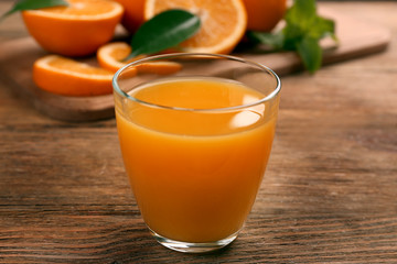 Fresh orange juice with fruits on table