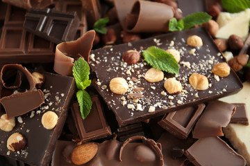Heap of broken chocolate pieces with mint, close up
