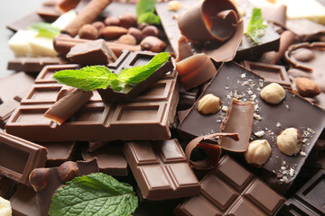 Heap of broken chocolate pieces with mint, close up