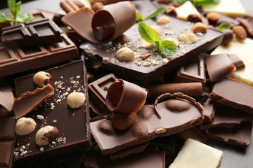 Heap of broken chocolate pieces with mint, close up