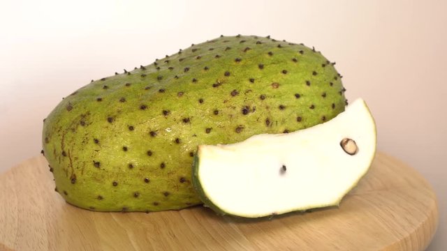 Soursop, Prickly Custard Apple with slice rotate on wooden cutting board
