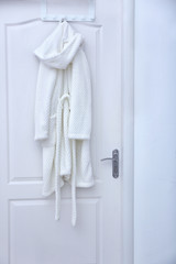 Spa bathrobe hanging on door