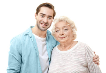 Young man with grandmother on white background