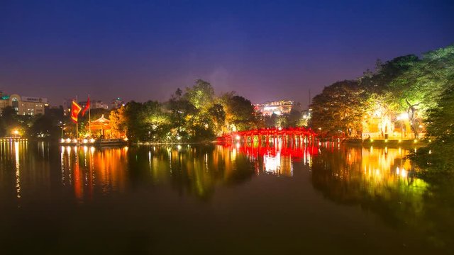 Time lapse Tourists visit Hoan Kiem Lake Public park at night time in Hanoi city. Hoan Kiem Lake has mean " Lake of the Returned Sword" it one of Famous tourist destination in Vietnam.