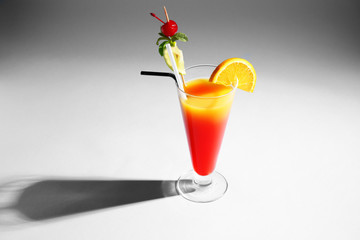 Tequila Sunrise cocktail in glass on dark background