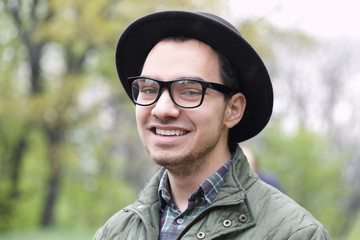 Portrait of young smiling man on blurred background