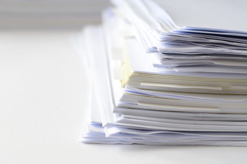 Stack of business documents on white table with high key tone,use for backdrop or web design. 