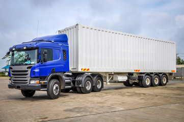 photo of big tractor, with container trailer, to deliver goods and products