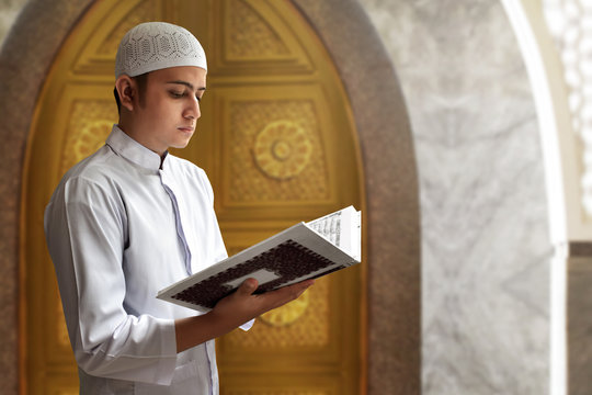 Muslim man reading koran in mosque
