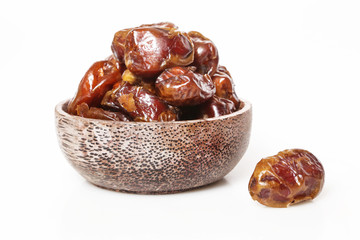 Dried dates in small bowl - studio shoot on the white