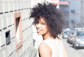 Fototapeta na wymiar Girl with afro posing, smiling.