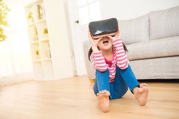 little girl experience looking in VR glasses