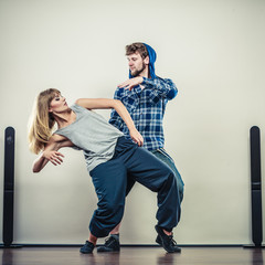couple of young man and woman dancing hip-hop