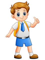Cute boy in a school uniform giving thumbs up
