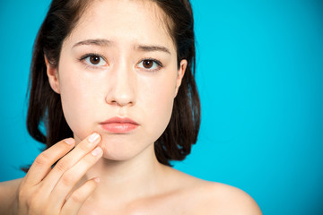 young woman who checks her skin. acne treatment.