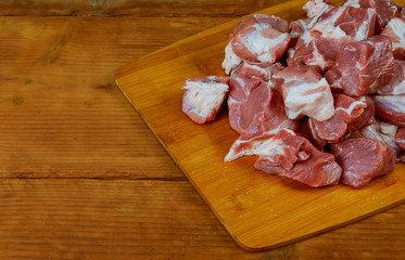 raw pork meat slices on a wooden board