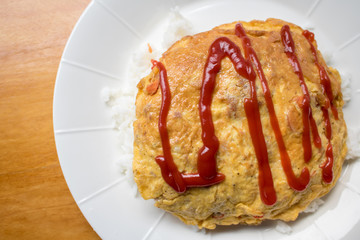 Tradition omelet with above rice with tomato sauce on top