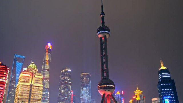 View of Shanghai Skyline at night. Oriental Pearl Tower and Huangpu River.