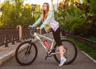 Naklejka premium Portrait of young beautiful blonde girl with bicycle